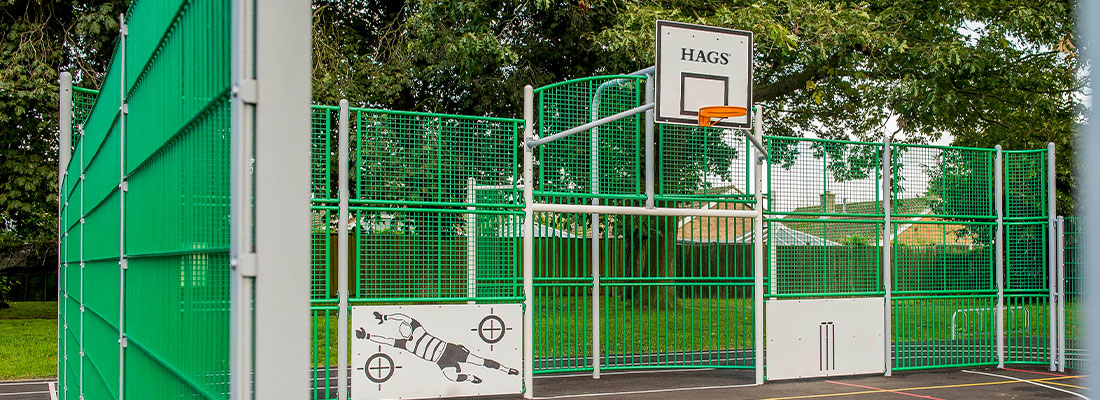 multi-sports court with basketball hoop and football goal 